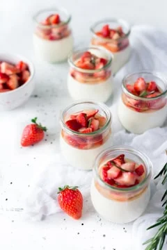 Fresh strawberry yogurt dessert cups served in small glass jars